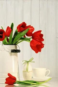 Tulips and egg with bow on table Stock Photos