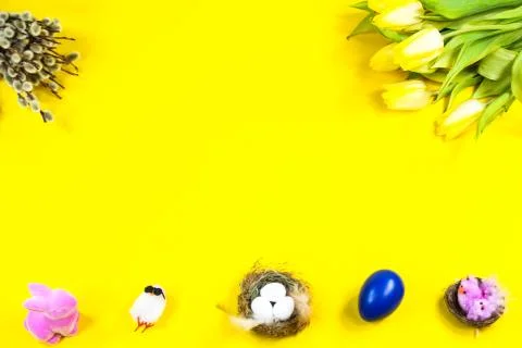 Tulips, Easter egg, Easter basket on yellow background, palm kitten Stock Photos
