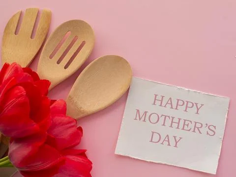 Tulips flowers with kitchen tools on background with Happy mothers day Stock Photos