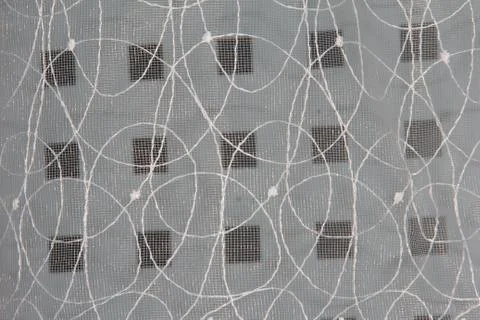 Tulle with a geometric pattern. Cubes on the background of openwork Stock Photos