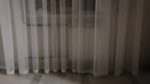 The tulle on the window flutters in a light wind, and it's night outside Stock-Footage 158820725