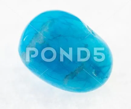 Tumbled blue howlite (turquenite) stone on white Stock Photos