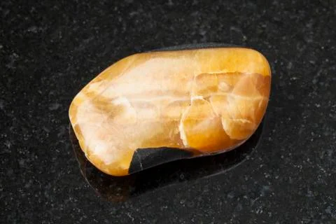 Tumbled simbircite gemstone on dark Stock Photos