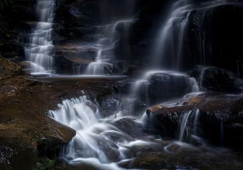 Tumbling mountain stream cascading over rocks Stock Photos