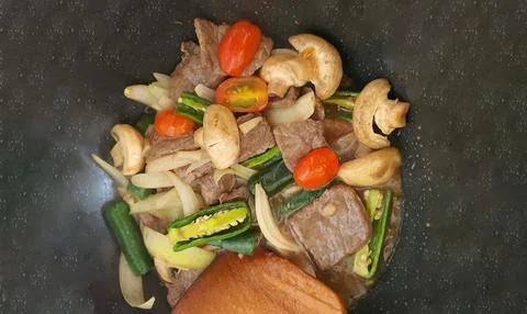 Tumis Daging Sapi Mercon or Stir fry or sauteed of beef with onion, red cay.. Stock Photos