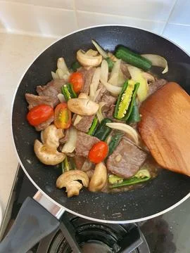 Tumis Daging Sapi Mercon or Stir fry or sauteed of beef with onion, red cay.. Stock Photos