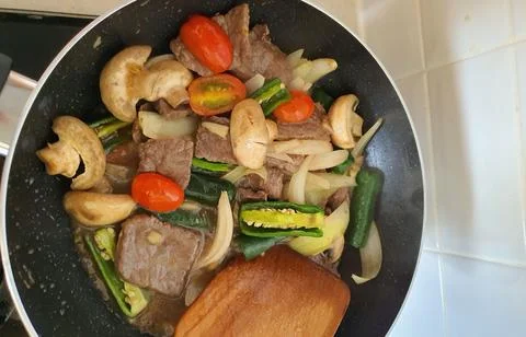 Tumis Daging Sapi Mercon or Stir fry or sauteed of beef with onion, red cay.. Stock Photos