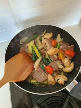 Tumis Daging Sapi Mercon or Stir fry or sauteed of beef with onion, red cay.. Stock Photos