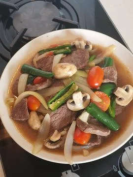 Tumis Daging Sapi Mercon or Stir fry or sauteed of beef with onion, red cay.. Stock Photos