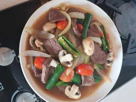 Tumis Daging Sapi Mercon or Stir fry or sauteed of beef with onion, red cay.. Stock Photos