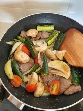Tumis Daging Sapi Mercon or Stir fry or sauteed of beef with onion, red cay.. Stock Photos
