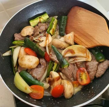 Tumis Daging Sapi Mercon or Stir fry or sauteed of beef with onion, red cay.. Stock Photos