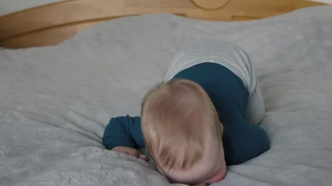 Tummy time discovery with curious baby Stock Footage 336328341