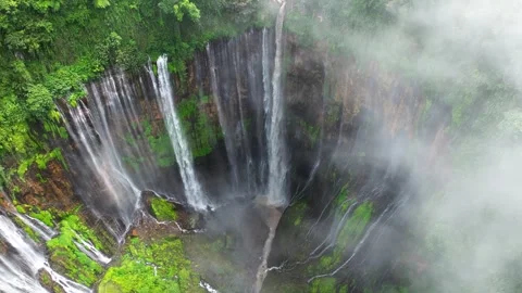 Tumpak Sewu Waterfall Java Indonesia Drone Through Clouds Pan Down Video stock 305116876