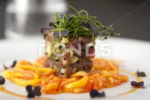 Tuna avocado tartar on ginger carrots with bean sprouts Stock Photos