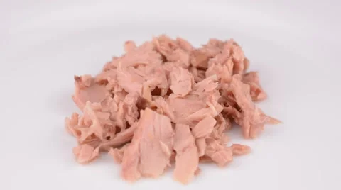 Tuna chunkson white plate rotating Stock Footage 65227878