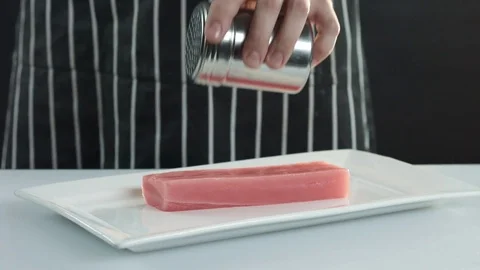 Tuna fillets are sprinkled with sesame seeds Stock Footage