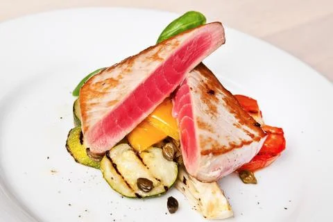Tuna steaks with vegetables Stock Photos