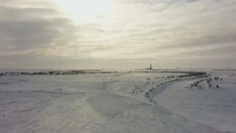 Tundra in the snow. Drilling platform in the distance. Aerial view. Bend of Stock Footage 145489239