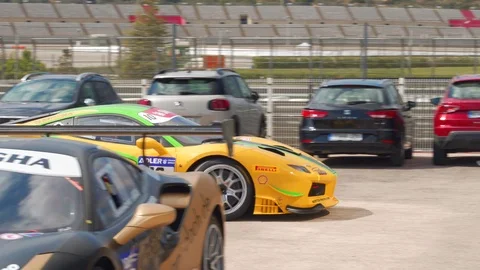 Tuned yellow Ferrari 488 Challenge  getting to the track. Racing. Stock Footage 105682006