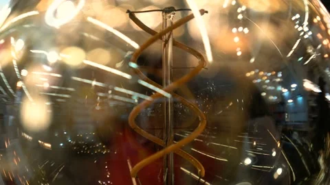 Tungsten filament lamp macro. Reflection on glass of lamp when idea came closeup Stock Footage 98337534