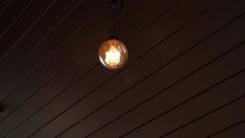 A tungsten light bulb is lit outside the house Stock Footage 162038174