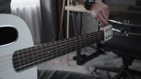 Tuning Acoustic Guitar Strings by Hand in Home Studio Vídeo Stock 329559820