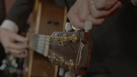 Tuning the guitar Stock Footage 101960099
