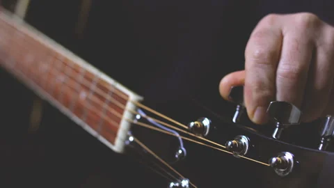 Tuning guitar strings Stock Footage 167791375
