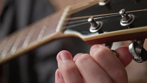 Tuning a musical instrument. close up of string and fingers Stock Footage 301309023