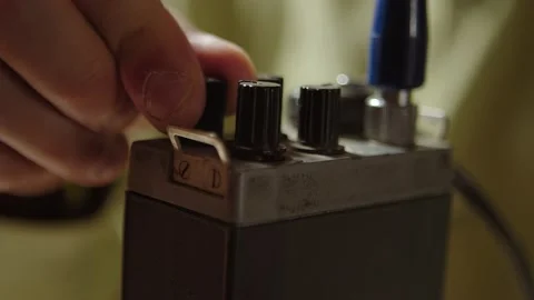 Tuning or setting old walkie talkie, extreme closeup of finger and knobs Stockbeeldmateriaal 160109993
