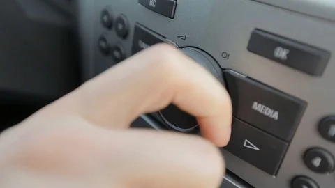 Tuning Radio Volume. Close up of hand adjusting car radio volume Stock Footage