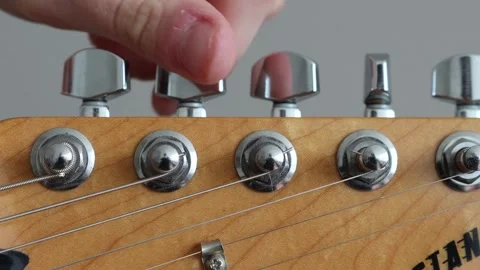 Tuning strings on an electric guitar Stock Footage 333462784