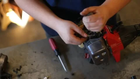 Tuning weedwhacker trimmer engine working on 動画素材 10588451