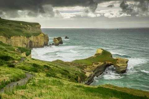 Tunnel beach view during cloudy weather, Dunedin, New Zealand Stock Photos