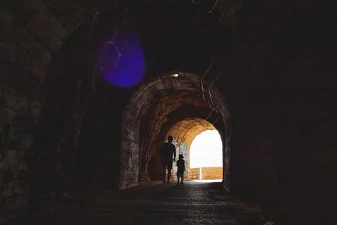 Tunnel cut out in the cliffs on the walking path Stock Photos
