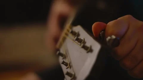 Tunning an acoustic guitar Stock Footage 284936799