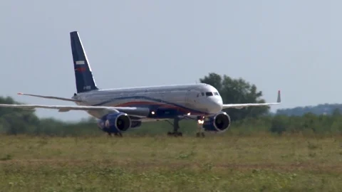 Tupolev Tu-204 medium-range passenger aircraft taxis of runway after landing. Stock Footage 115696015