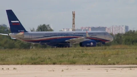 Tupolev Tu-204  medium-range passenger plane leaves runway on taxiway. Close-up. Stock Footage 115696130