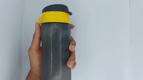 Tupperware branded drinking bottles in black and yellow Stock Photos