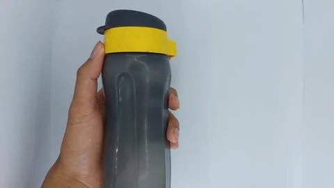 Tupperware branded drinking bottles in black and yellow Stock Photos
