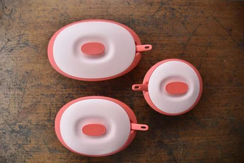 Tupperware serving set with wood table background Stock Photos