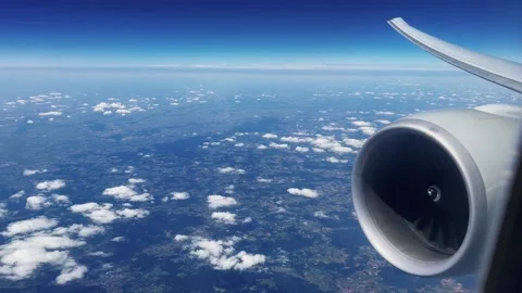 Turbine jet engine on an airliner flying on sunny day, pov from the passenger Video stock 299500903