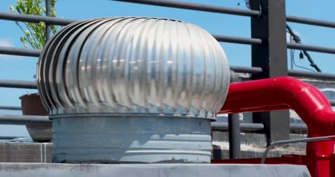 Turbine ventilator spinning in the wind on rooftop, ventilator stainless Stock Footage 336976048