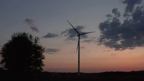 Turbine windmill Arial drone pan with golden sky and clouds Video stock 122989398