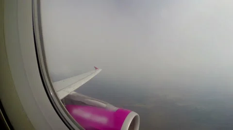 Turbulence flying through clouds, airplane shaking porthole view Stock Footage 43956422