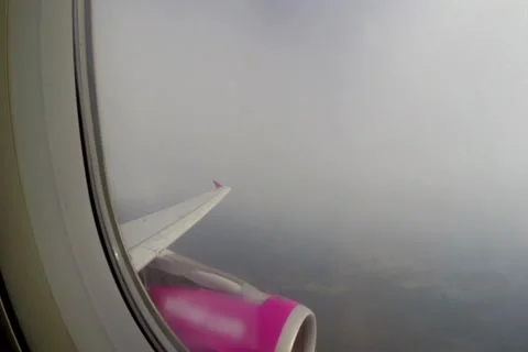 Turbulence flying through clouds, airplane shaking porthole view, click for HD Stock Footage 43967564