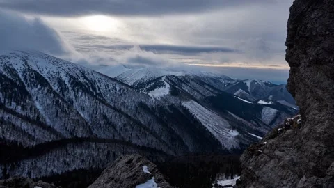 Turbulent clouds undulate over the tops of the hills in winter Spruce stands Stock Footage 169276747