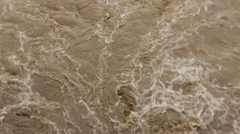 Turbulent flood river fast flowing,muddy water,close up. Stock Footage