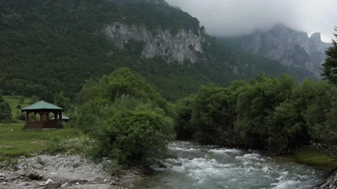Turbulent flow of a mountain river. rainy weather in a mountain valley. Stock Footage 245434111